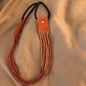 Gold metal beads on a suede stretchable headband.